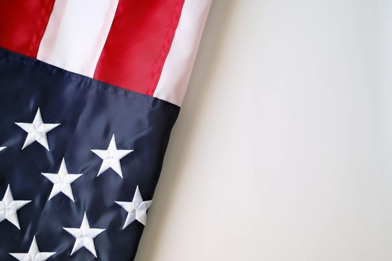 close up of american flag against neutral background