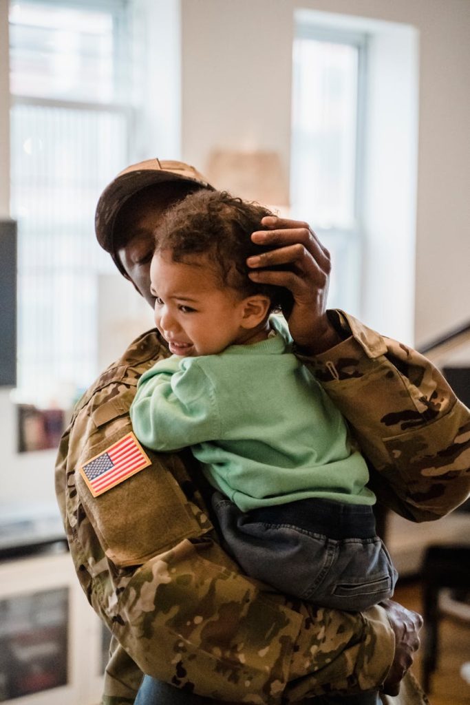 soldier holding his crying son