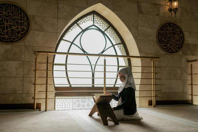 girl reading quran inside a mosque