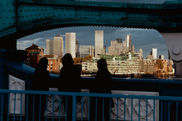 silhouetted figures with canary wharf skyline