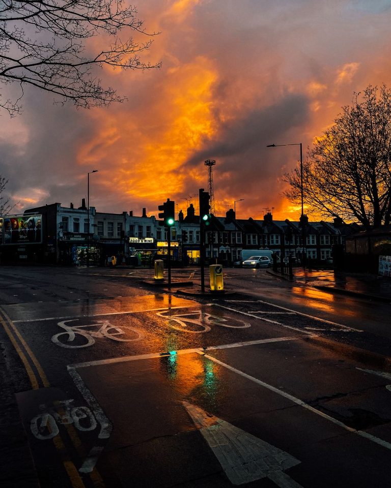 photograph of a road in a city during sunset