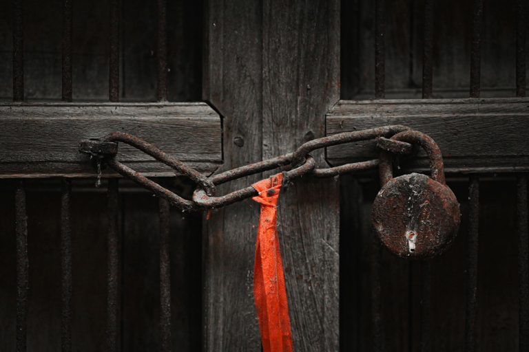 a red lock on a wooden door