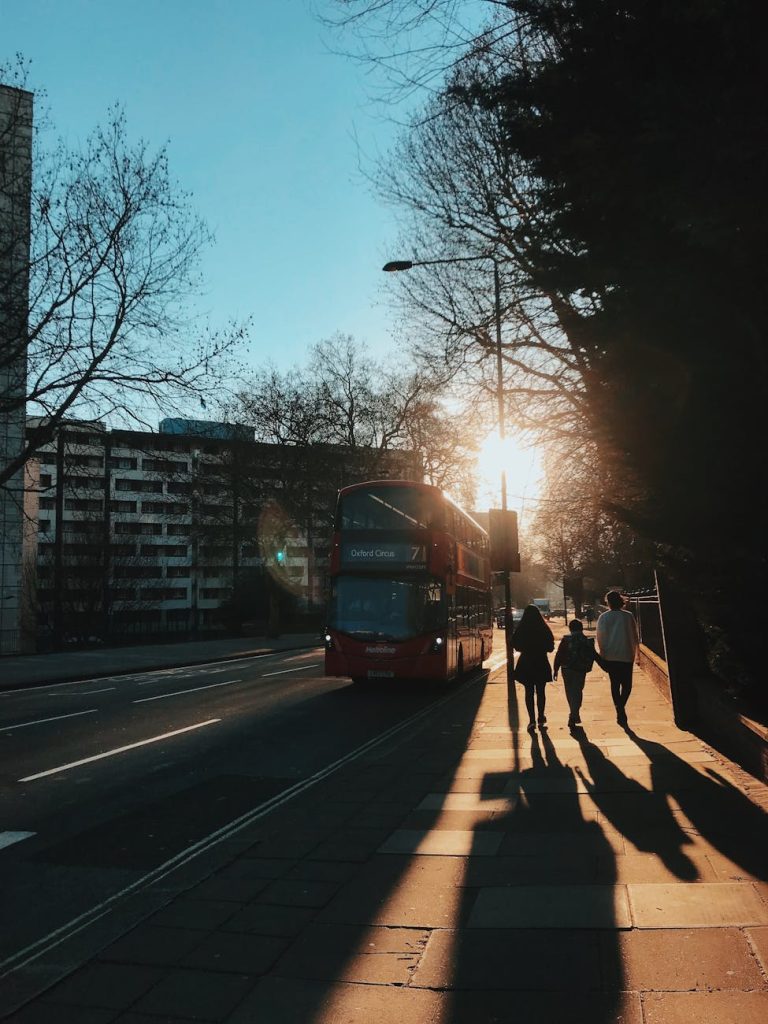 photograph of people walking on a sidewalk