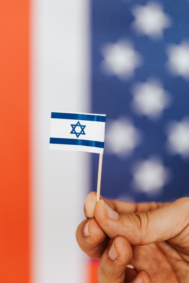 crop person with israeli flag on multicolored background